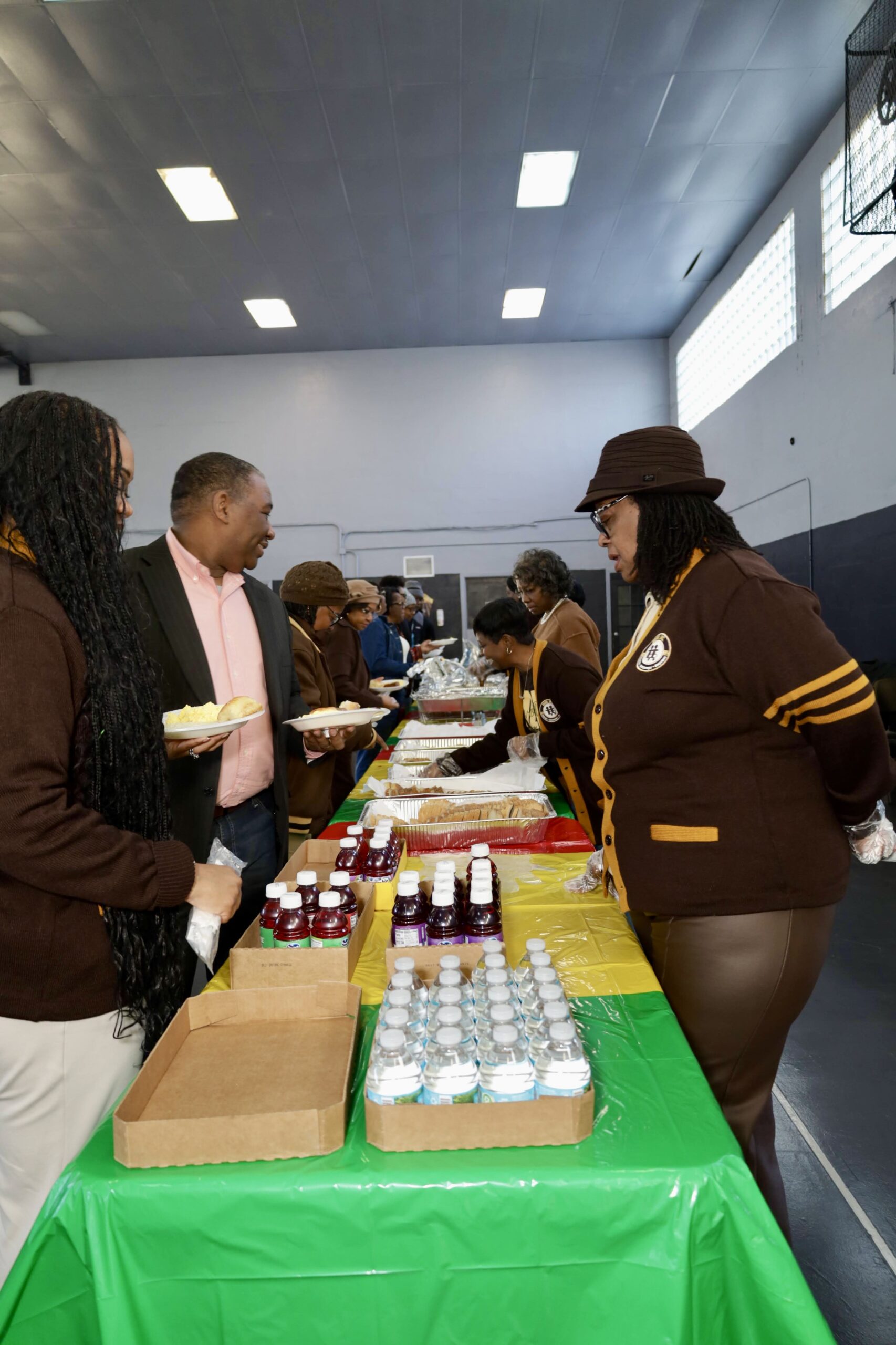 A close-up foreground image of an arson reward sign attached to a tree with caution tape, with the fire-damaged church visible in the background.