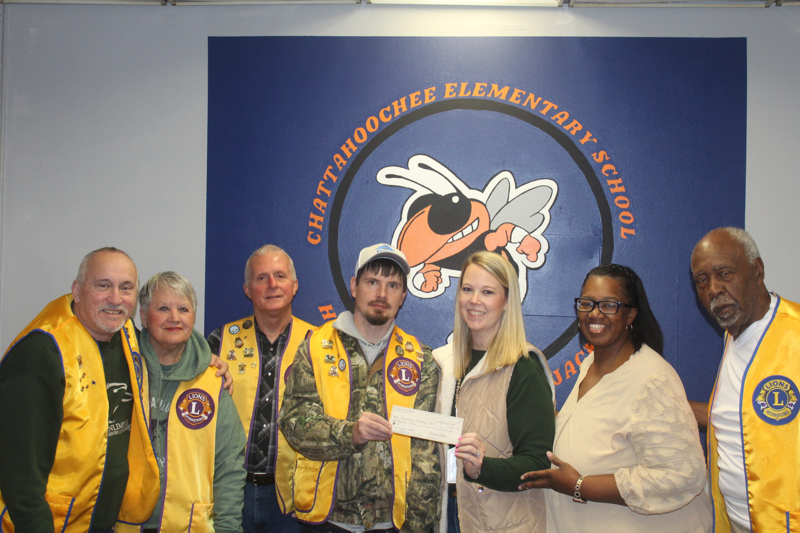 Chattahoochee Elementary School donation presentation with Lions Club members awarding a check to school representatives, community partnership event supporting local education in Chattahoochee, Florida.