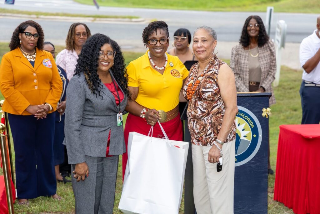 City and county officials standing together at an outdoor podium during Midway's 40th anniversary celebration