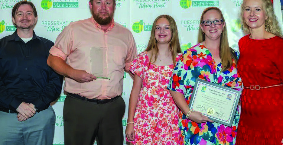 Group photo at the Florida Main Street conference showing Josh Kever, Roger and Bridgette Rankin, their daughter Lilly, and Melissa Wylie holding an award certificate.